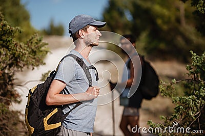 Two hikers men walk on trek in mountain. Trekking in mountains. Hills and mounts in sport tourism Stock Photo