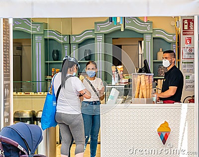 Two Hispanic Girls and Child in Face Masks, Buy Ice Cream, Coronavirus outbreak Editorial Stock Photo