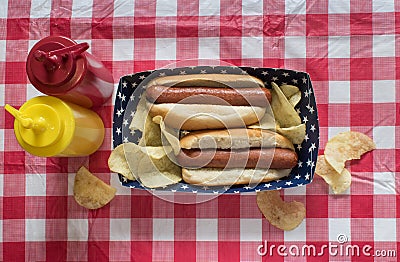 Two hog dogs with chips on Fourth of July setting with mustard and ketchup Stock Photo