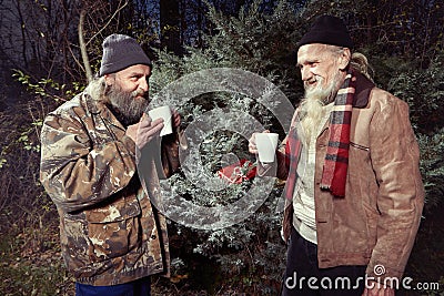 Two homeless men celebrating their christmas in park Stock Photo