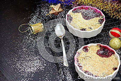 Two Homemade delicious crumble with berries in portioned ramekin Stock Photo