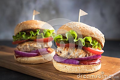 Two homemade turkey burgers with vegetables. Stock Photo