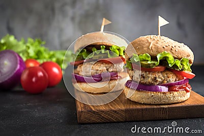 Two homemade turkey burgers with vegetables. Stock Photo