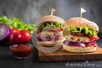 Two homemade turkey burgers with vegetables. Stock Photo