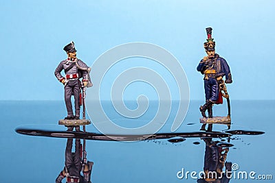 Two hussars from the Napoleonic Wars stand in front of a puddle of water Stock Photo