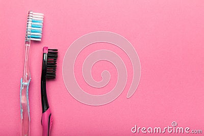 Two hygienic toothbrushes on a pink background. Copy space Stock Photo