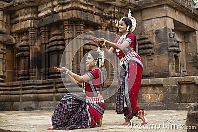 Two Indian classical odissi dancers Pushpanjali in front of Mukteshvara Temple,Bhubaneswar, Odisha, India Stock Photo