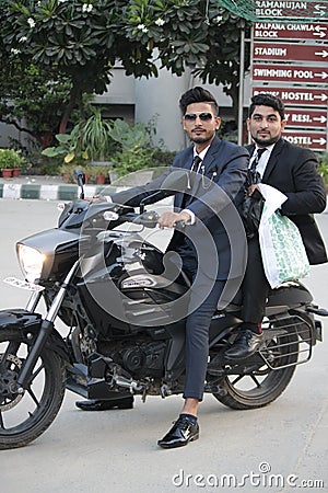 Two indian friends sitting on bike Editorial Stock Photo