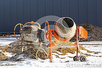 Two industrial concrete mixers at construction site Stock Photo