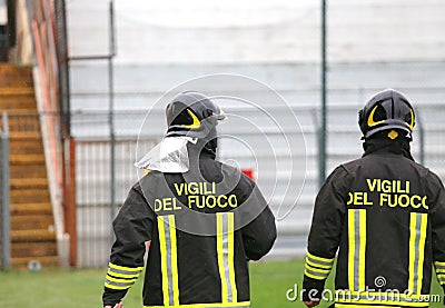 two Italian firefighters with uniform with the written FIREFIGHT Stock Photo