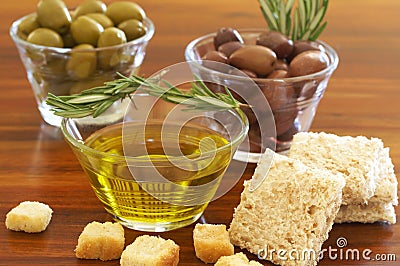 Two jars of green and black olives and croutons Stock Photo