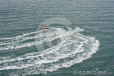 Two jet skis or personal watercraft speeding across the ocean Editorial Stock Photo