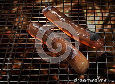 Juicy hot dogs cooking on the BBQ Stock Photo