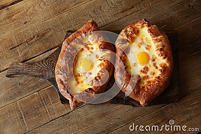 Khachapuri Adjara traditional Georgian dishes. Baked bread stuffed with cheese and eggs. Stock Photo