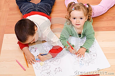 Two kids coloring on the floor Stock Photo