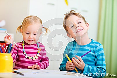 Two kids drawing with coloring pencils Stock Photo