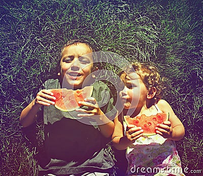 Two kids eating watermelon done with a retro vintage instagram f Stock Photo