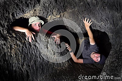 Two Kids Exploring Cave Stock Photo