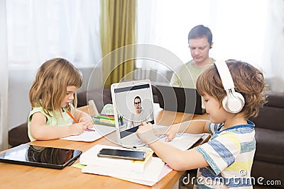Two kids learn at home online. Stock Photo
