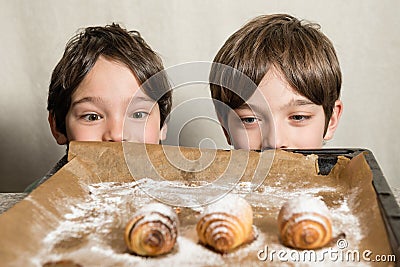 Kids looking at freshly baked spiral cookies Stock Photo