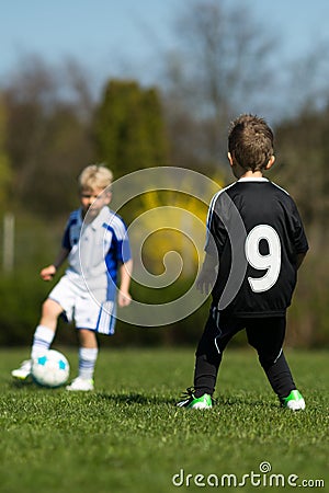 Two kids playing soccer Stock Photo