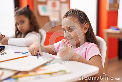 Two kids preschool students drawing on paper doing ok gesture at classroom Stock Photo