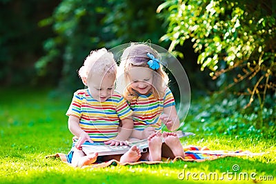 Two kids reading in summer garden Stock Photo