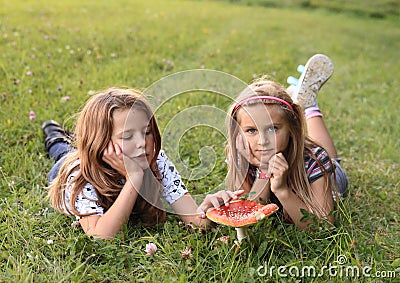 Two kids with red toadstool Stock Photo