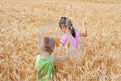 Two kids on a wheat field Stock Photo