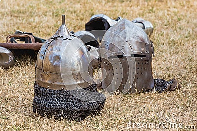 Two knightly helmets on the grass in the break between fights_ Stock Photo