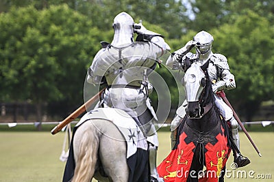 Two knights salute during medieval jousting tournament Stock Photo