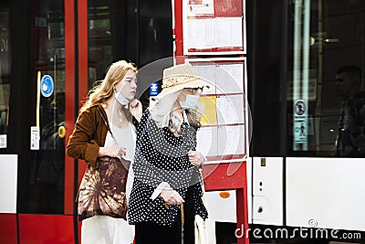 Two ladies at Prague Tram stop one wearing mask Covid -19 second wave 2020 Editorial Stock Photo