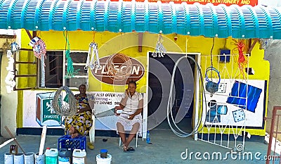 Two ladies sitting infront of small hardware store in Mongu, a small town in Africa Editorial Stock Photo