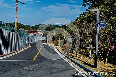 Two lane paved road beside construction site Stock Photo