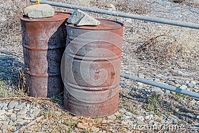 Two large rusted oil drums Stock Photo