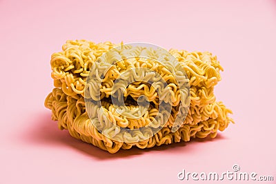 Two large servings of raw instant noodles on a pink background. Stock Photo