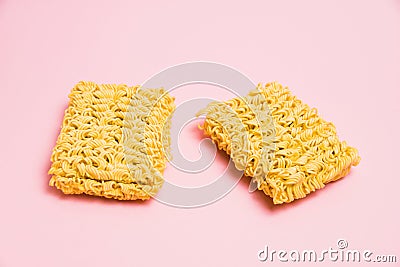 Two large servings of raw instant noodles on a pink background. Stock Photo