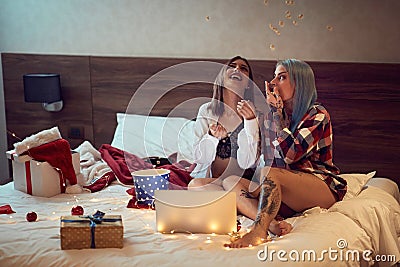 Two lesbian girls eating popcorn Stock Photo