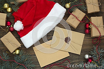 Two letters, santa hat among gifts and Christmas Stock Photo