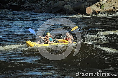Two in life jackets and helmets rowing boat Editorial Stock Photo