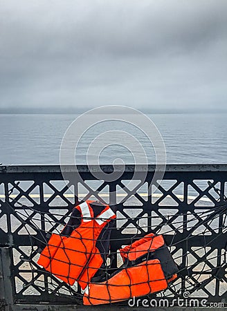 Two life vests stowed in safety netting on car ferry. Stock Photo