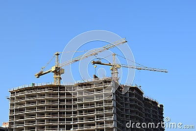 Two lifting crane and building under construction. Stock Photo