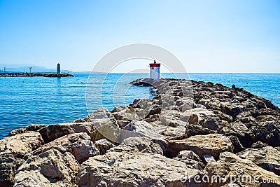 Two lighthouses located on the rocks of the breakwaters that protect the entrance to the marina Stock Photo