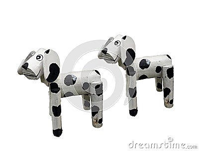 Two of litle wooden dogs white mixed black colored standind isolated on white background Stock Photo