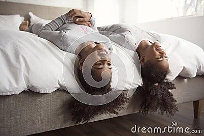 Two little african american girls on bed at home Stock Photo