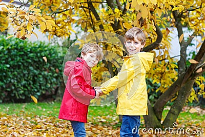 Two little best friends and kids boys autumn park in colorful clothes. Stock Photo