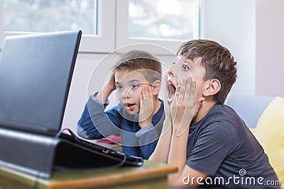 two little boys enjoying using internet on laptop Stock Photo