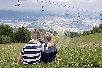 Two little boys friends hug each other in summer sunny day. Brother love. Concept friendship. Back view Stock Photo