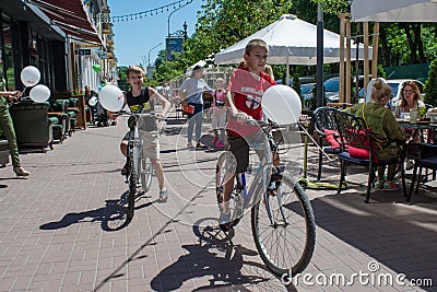 Two little boys riding bicycles with baloons during children protection day Editorial Stock Photo