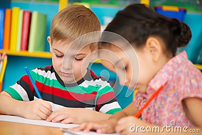 Two little children drawing at kindergarten Stock Photo